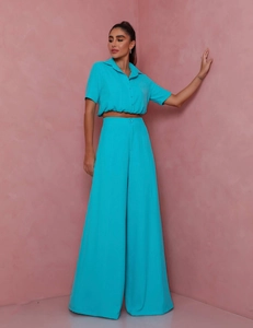 Detail of teal short sleeve crop top and high waist wide leg trousers two-piece set
