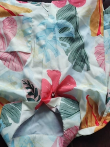 Detail view of tropical floral print shirt with chest pocket and monstera leaf pattern