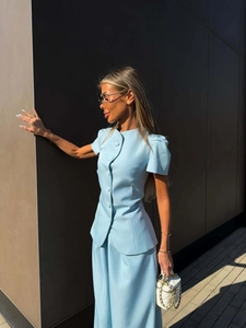 Close-up of light blue two-piece set featuring short sleeve top and high waist maxi skirt