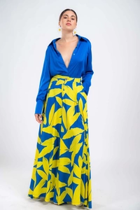 Detail of royal blue satin shirt and high-waisted floral print maxi skirt on model