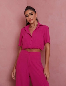 Detail of rose red short sleeve cropped shirt and high waist wide leg pants set