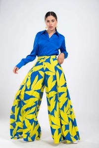Close-up of royal blue satin shirt and floral high-waisted wide-leg pants set
