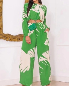 Detail of green leaf print crop top and high waist wide leg trousers two-piece set
