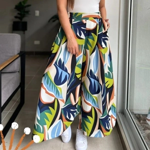 Detail of high-waisted wide-leg trousers with tropical print and elastic waistband
