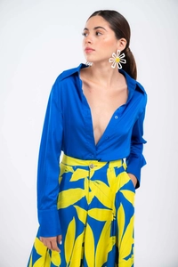 Close-up of royal blue satin V-neck shirt with luxury silk texture and bold floral pattern