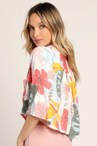 Detail of short-sleeved tropical floral print blouse with pleated crop tailoring
