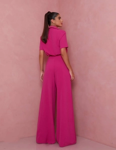 Detail of magenta short-sleeved collared shirt and high-waist wide-leg pants set