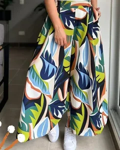 Detail of high waisted wide leg pants with colorful tropical botanical print and elastic band
