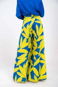 Rear view of high-waisted wide-leg pants with blue and yellow tropical leaf print fabric