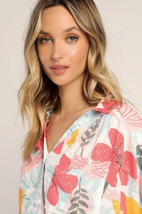 Close-up of floral print shirt featuring vibrant pink and blue blossoms on woven fabric