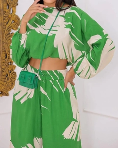 Detail of printed long sleeve crop top and high waist wide leg pants set with plant motifs