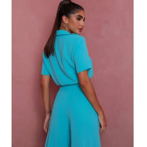 Detail view of turquoise short sleeve crop top and high waist wide leg pants set from back