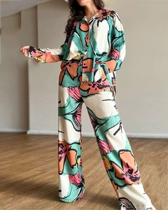 Detail of high-waist wide-leg pants and button-up shirt in abstract floral print set