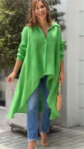Detail showing the vibrant green high-low hemline and loose fit of the long sleeve shirt