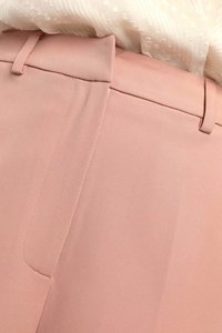 Close-up of high-waist mauve trousers featuring twill texture and belt loop detailing