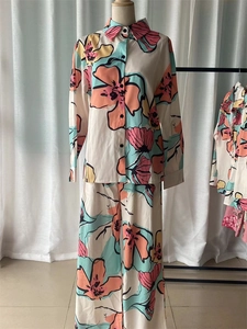 Detailed view of women's long sleeve shirt and wide leg pants with colorful floral prints
