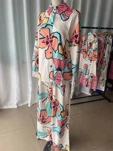 Detail showing high-waist wide-leg pants with bold abstract floral print for women
