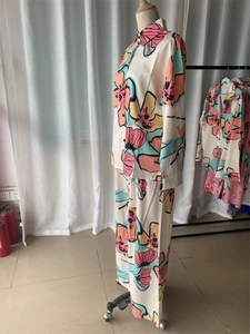 Macro detail of silky abstract floral printed shirt and trousers two-piece outfit