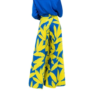 Women's two-piece set featuring royal blue satin shirt and yellow leaf print wide leg pants