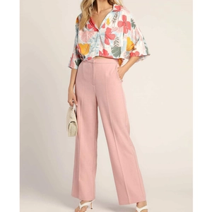 Women's chic resort set featuring a floral short sleeve shirt and pink wide leg trousers
