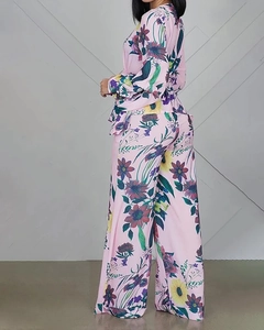 Detail of floral print V-neck top and wide-leg trousers set with puffy sleeves