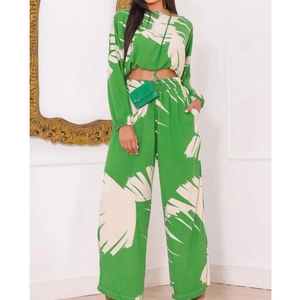 Green and white floral print two-piece set with cropped long sleeve top and wide leg pants