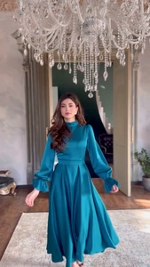 Détail d'une robe longue en satin sarcelle avec volants et lustre soyeux élégant
