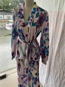 Detail of floral printed V-neck top and wide-leg pants set in light pink fabric