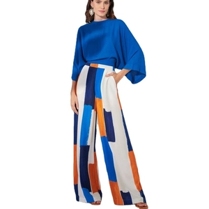 Women's pleated blue batwing sleeve top and high-waisted geometric color block wide-leg pants