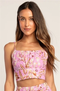 Close-up of pink floral print texture and ruffled details on the spaghetti strap crop top