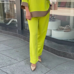 Women's 2-piece oversized neon green lounge set with contrast brown cuffs and straight pants