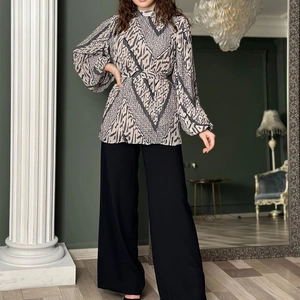 Elegant two-piece set featuring a printed puff sleeve blouse and black wide-leg trousers