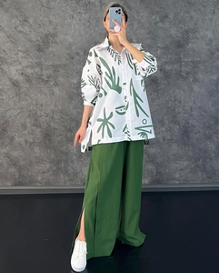 Détail du pantalon large à taille haute fendu et chemise à imprimé floral vert femme