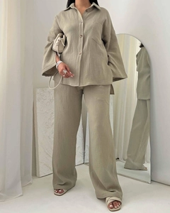 Detail of sage green textured fabric on plus size long sleeve shirt and wide leg pants set
