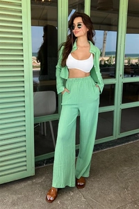 Detail of light green two-piece set featuring vertical pleated texture on fabric
