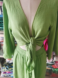 Detail view of grass green two-piece set featuring crinkle texture fabric and front tie design