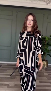 Detail of elegant geometric pattern maxi dress with pearl beads on long sleeves