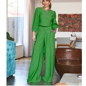 Women's two-piece set featuring bright green long sleeve top and high waist wide leg pants