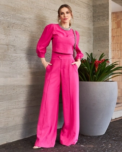 Detailed texture of fuchsia two-piece set featuring short top and wide-leg trousers
