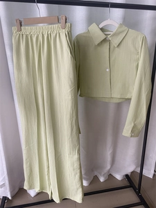 Detail of the textured vertical stripe fabric on the pale green shirt and pants set