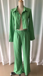Detail of the grass green textured fabric on short crop top and wide-leg pants set