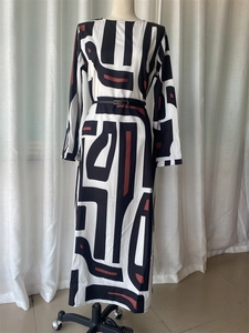 Detail of elegant geometric print maxi dress with long sleeves and black waist belt