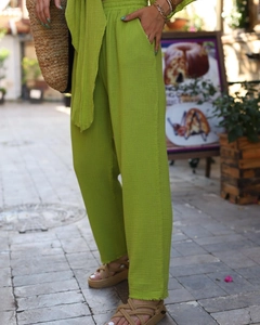 Detail of lime green crinkle cotton two-piece set showing elastic high waist and pocket texture