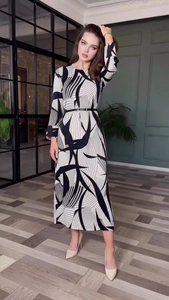Detail of elegant black and white geometric print dress with a slim black waist belt