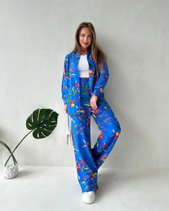Detailed view of women's two-piece set with vibrant floral print and wide-leg trousers
