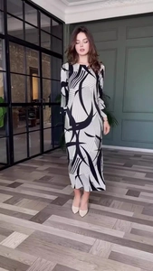 Detail of elegant black and white abstract geometric pattern on long sleeve maxi dress