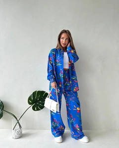 Detail of vibrant tropical floral print two-piece set with silk-texture shirt and wide-leg pants