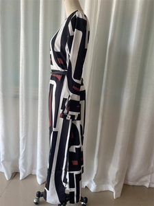 Detail of elegant geometric pattern maxi dress with side slit and waist belt