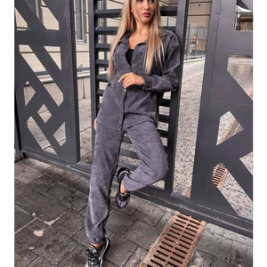 Detail of dark grey corduroy two-piece set featuring elastic cuffs and metal buttons