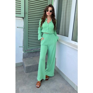 Women's light green two-piece set featuring cropped shirt and high-waisted wide-leg trousers